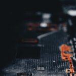 Our products Close-up of a dark circuit board showcasing electronic components and connections.